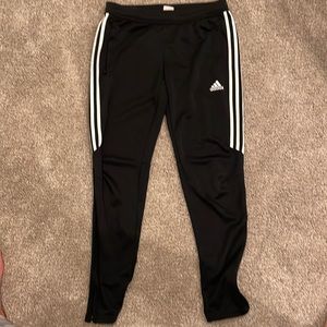 Size medium women Adidas joggers with zipper pockets and on pant leg